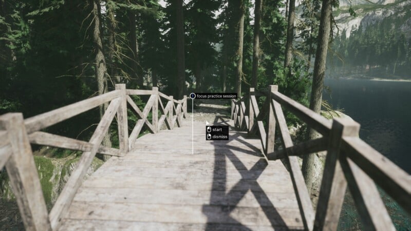 A rustic wooden bridge stretches through a lush forest with tall green trees. A serene lake is visible in the background. In the center, a virtual prompt offers options to start or dismiss a focus practice session.