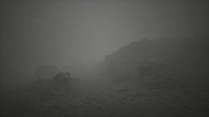 A foggy landscape with large rocks scattered across the terrain. The scene is dimly lit, creating an eerie and mysterious atmosphere. The visibility is low due to the thick fog enveloping the area.