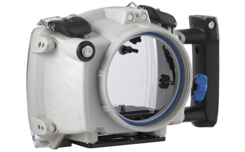 A professional underwater camera housing with a large, clear front lens port, gray body, and black and blue accessories. The housing features buttons and levers for camera control, with a handle for easy maneuvering.