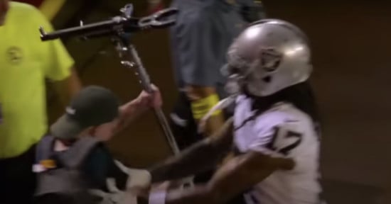 Davante Adams pushes a cameraman