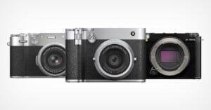 Three Fujifilm digital cameras are displayed side by side, with the two on the left featuring attached lenses and a vintage-style silver and black design, while the camera on the right is black and lacks a lens, revealing the sensor.