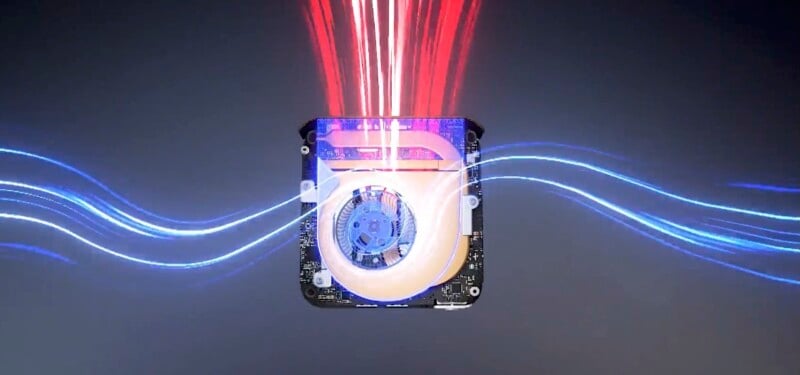 An electronic device or component with a circular fan in the center. Blue and red light trails flow in and out, suggesting dynamic motion and energy. The background is a gradient of dark colors.