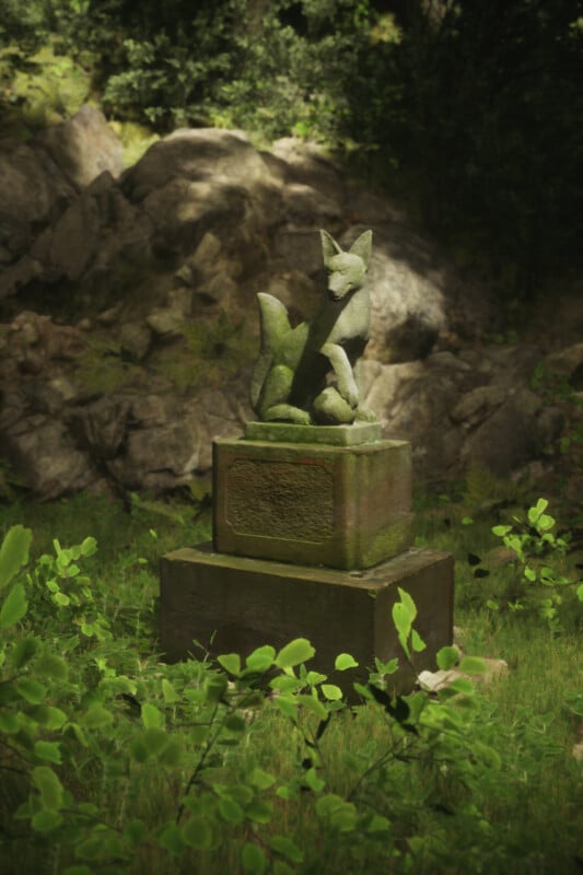 A moss-covered stone statue of a fox sits on a rectangular pedestal in a lush, green forest setting. The background features rocky terrain and dense foliage. Sunlight filters through the trees, highlighting the statue.
