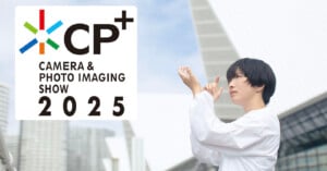 A person in a white shirt stands outdoors, looking off-frame with hands raised thoughtfully. The background features modern architecture. Text on the image reads "CP+ Camera & Photo Imaging Show 2025" with a colorful logo.