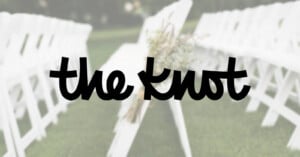 The logo for "the knot" in black script font is centered over a blurred background of white chairs arranged outdoors, suggesting a wedding ceremony setting.