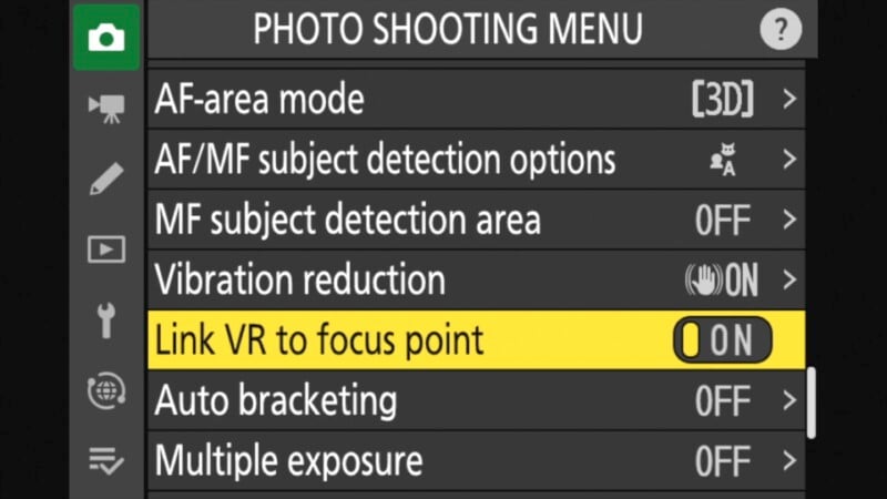 Camera photo shooting menu screen showing options like AF-area mode set to [3D], Vibration reduction ON, and Link VR to focus point highlighted and set to ON. Other options include Auto bracketing and Multiple exposure both set to OFF.