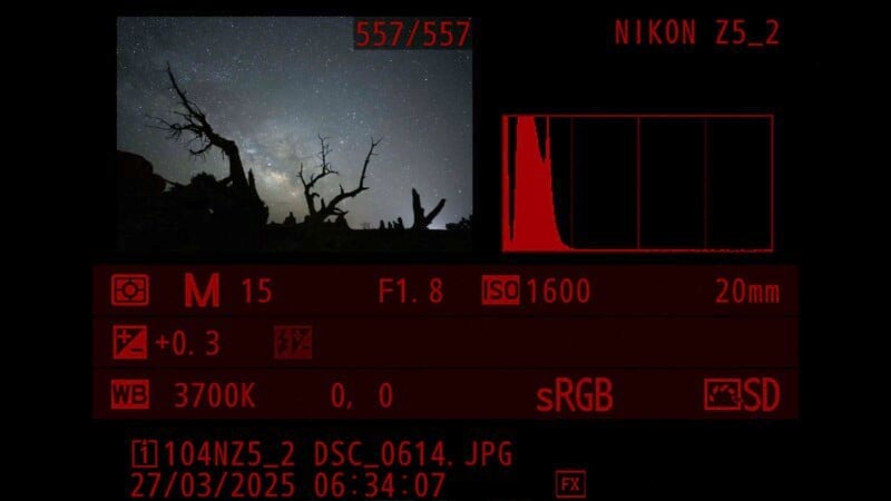 Camera display showing a nighttime landscape photo with silhouetted trees against a starry sky. Settings: M mode, 15s exposure, f/1.8, ISO 1600, 20mm lens, +0.3 exposure compensation, 3700K white balance. Histogram visible.