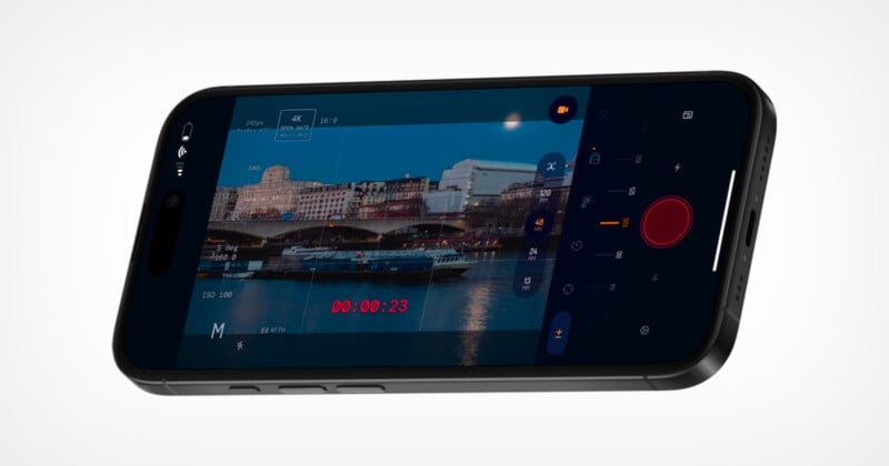 A smartphone displaying a camera app interface, showing a video recording of a cityscape with buildings, a river, and boats, along with camera controls and a recording timer on screen.