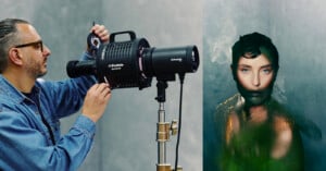 A man adjusts a large studio light on the left, while on the right, a woman with striking makeup and slicked hair poses with smoky effects and green lighting in front of her.
