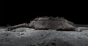 A digitally rendered 3D model of the Titanic shipwreck, resting on the ocean floor. The ship’s structure is corroded and fragmented, with a dark, deep-sea backdrop highlighting its haunting state.
